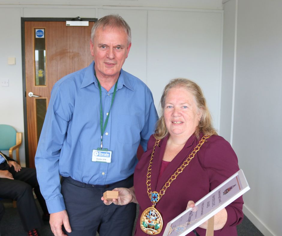 A man standing next to the mayor.