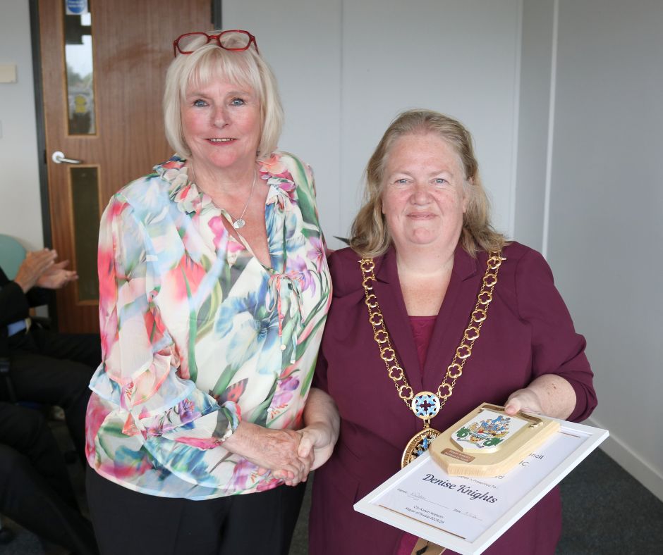 The mayor presenting an award to a woman