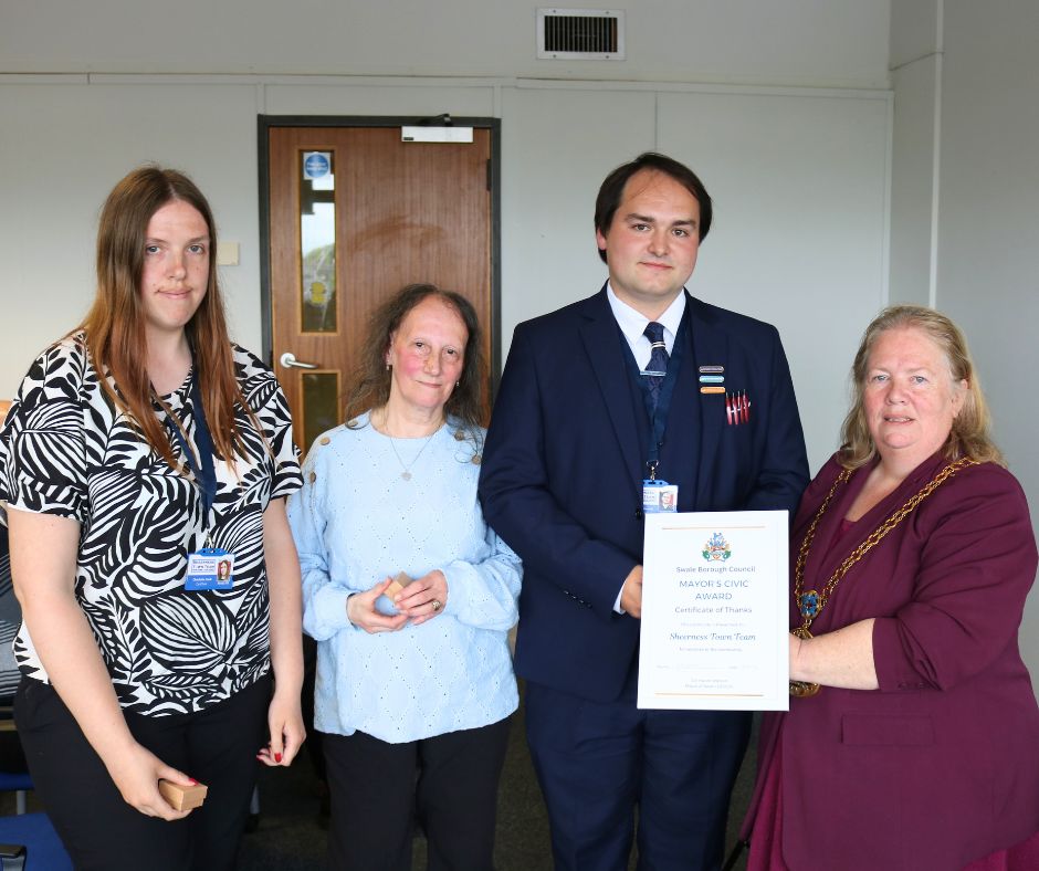 A group of people standing with the mayor